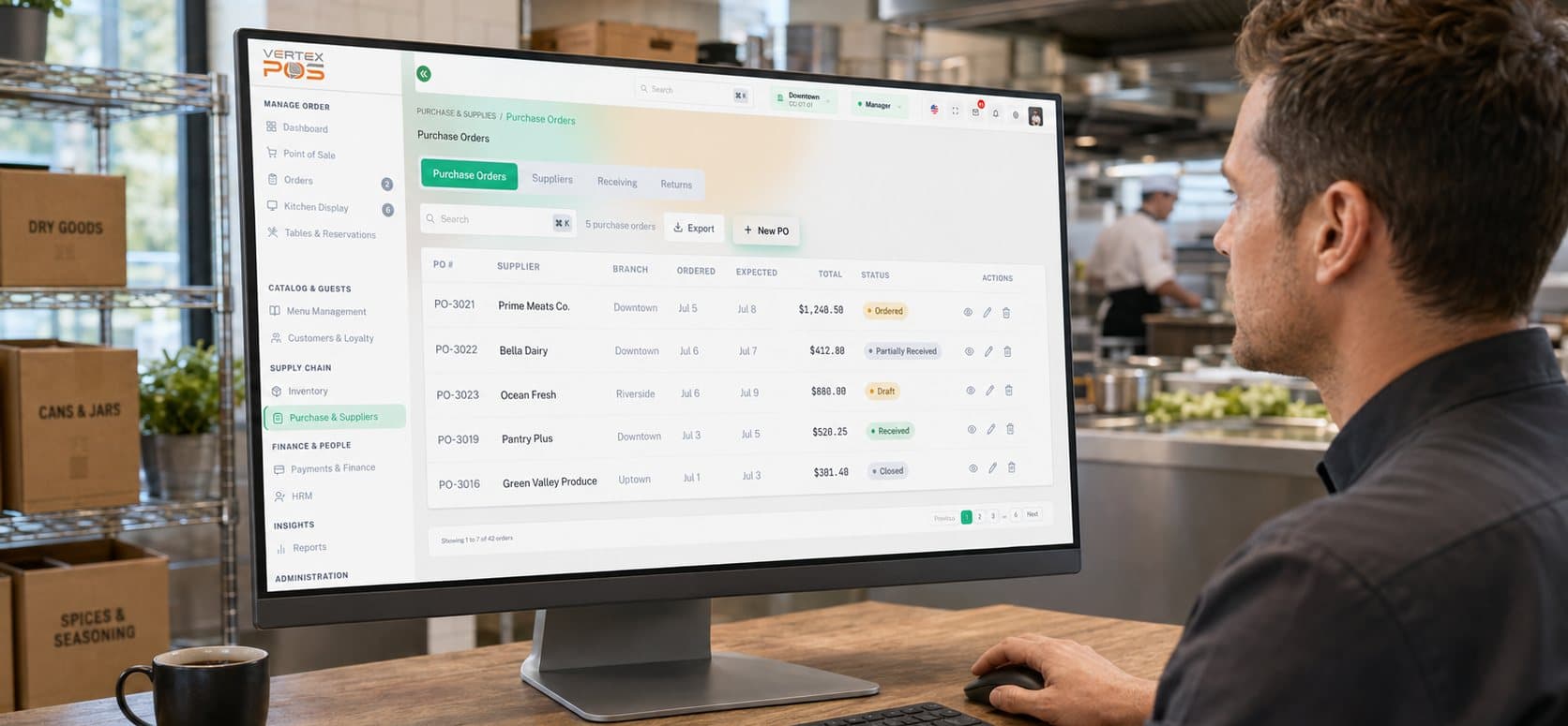 A manager reviewing the Vertex POS Purchase & Suppliers workspace on a desktop monitor in a restaurant kitchen. The Purchase Orders tab is selected alongside Suppliers, Receiving and Returns, above a sample purchase-order table with columns for PO number, supplier, branch, ordered and expected dates, order total and a colour-coded fulfilment status.